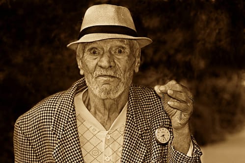 Funny picture of elderly man holding pocket watch