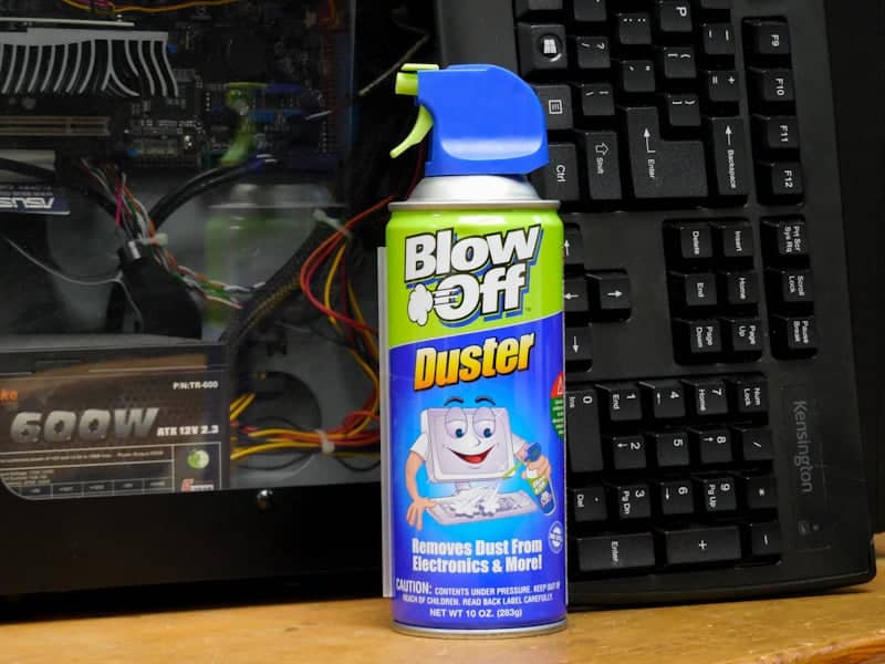 can of blow off duster with computer and keyboard