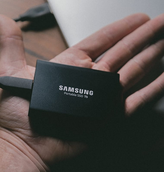Portable external hard drive in hand