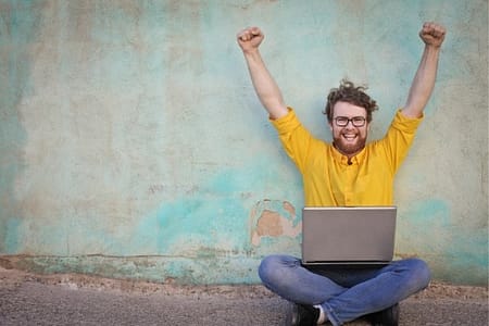 happy man with laptop computer